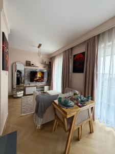 a living room with a table and a couch at Chic Retreat Near JKIA and SGR with Nairobi National Park Views in Nairobi