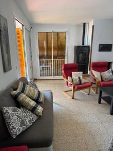 a living room with a couch and two chairs at Villa Escorpion Tossa de Mar in Tossa de Mar