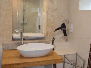 a bathroom with a white bowl sink on a counter at Gîte de charme avec jardin privatif près de la Loire - FR-1-381-95 in Montlouis-sur-Loire +22 photos