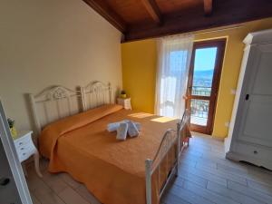 a bedroom with a bed with two towels on it at Colle Del Mirto in Castelnuovo Cilento