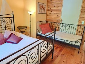 a bedroom with two beds and a lamp at Apartment in Alsace with Private Terrace in Dabo