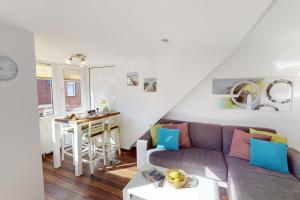 a living room with a couch and a table at Gorch Fock - 11 in Cuxhaven