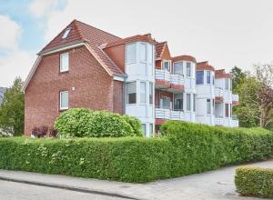 a large brick building with bushes in front of it at Gorch Fock - 11 in Cuxhaven