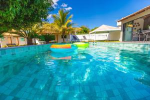a swimming pool with a boat in the water at Refúgio 4 Suítes c/ Piscina, Sinuca e Área Gourmet in Caldas Novas