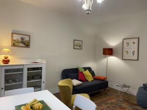 a living room with a couch and a table at Appartement à Moulins: Confort avec Balcon, Draps et Linge Inclus - FR-1-489-398 in Moulins