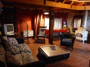 a living room with a couch and chairs and a bed at Fermette rénovée avec charme, 4 chambres, jardin, poêle bois, internet, animaux acceptés - FR-1-489-246 in Beaune dʼAllier