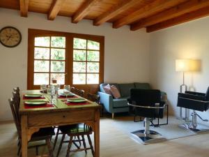 a living room with a table and a couch at Charmant Gîte avec Piscine Privative et Terrasse à Charroux, Village Médiéval - FR-1-489-394 in Charroux-dʼAllier