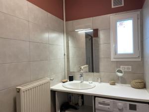 a bathroom with a sink and a mirror at Maison de ferme rénovée avec terrasse, jardin et équipements modernes à Taxat-Senat - FR-1-489-363 in Taxat-Senat +22 photos