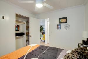 a bedroom with a bed and a white wall at 2 Mi to Arizona Christmas City! Cabin with Fireplace in Prescott