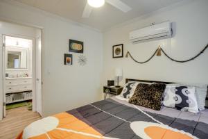 a bedroom with a bed and a air conditioner at 2 Mi to Arizona Christmas City! Cabin with Fireplace in Prescott