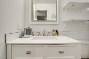 a white bathroom with a sink and a mirror at 2 Mi to Arizona Christmas City! Cabin with Fireplace in Prescott +19 photos