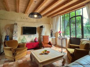 a living room with a couch and chairs and a tv at Maison Percheronne Indépendante avec Étang, Jardin et Dépendance, Proche Bellême - FR-1-497-158 in Le Pin-la-Garenne
