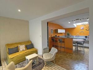 a living room with a couch and a kitchen at Maison granit avec jardin privatif, plain-pied, 2 chambres, tout inclus, proche loisirs et nature - FR-1-497-190 in Saint-Mars-dʼÉgrenne +18 photos