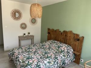 a bedroom with a bed and two mirrors on the wall at Gîte familial en Sologne avec grand jardin, jeux pour enfants et proche des châteaux et commerces. - FR-1-491-373 in Mur-de-Sologne