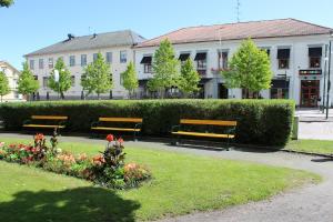 a row of park benches in front of a building at Hotell Läckö in Lidköping