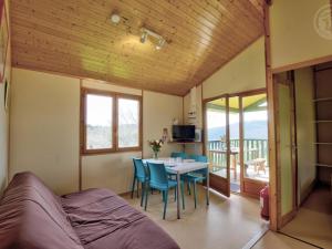 a room with a bed and a table and chairs at Chalet plain-pied dans les Monts de la Madeleine - FR-1-496-246 in Saint-Rirand