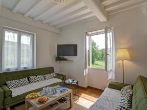 a living room with a couch and a table at Gîtes Champêtres Rénovés avec Terrasse, Jardin, et Activités pour Familles et Amis - FR-1-496-304 in Belmont-de-la-Loire