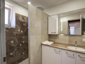 a bathroom with a sink and a mirror at Gîte de charme avec SPA, terrasse, cheminée et cour, idéal pour un séjour zen à Notre-Dame-de-Boisset - FR-1-496-320 in Notre-Dame-de-Boisset +25 photos