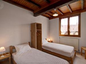 a bedroom with two beds and a window at Gîte de charme avec cheminée, balcon et jardin à St-Médard-en-Forez - FR-1-496-279 in Saint-Médard-en-Forez