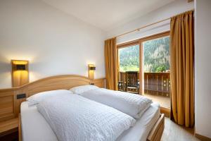Postel nebo postele na pokoji v ubytování Hotel Brunello