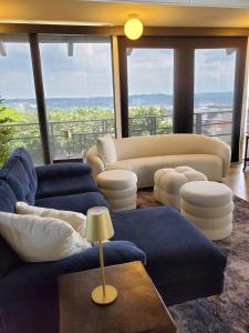 a living room with blue couches and a couch at Luxe Mt Adams Lookout in Cincinnati