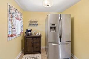 a kitchen with a stainless steel refrigerator in a room at Cozy Farmhouse near Mammoth Cave on 45 acre farm in Horse Cave