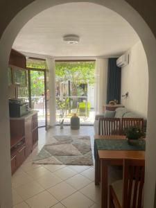 a kitchen with a living room with a couch and a table at Family Paradise in Laguna Beach Hotel in Sozopol