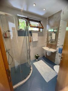 a bathroom with a shower and a sink at Family Paradise in Laguna Beach Hotel in Sozopol