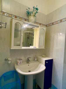a bathroom with a sink and a mirror at ONDA BLU in Diano Marina