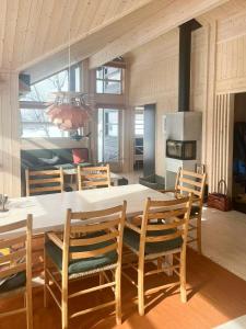 a dining room with a large table and chairs at Architectural Gem With Views Of Hallingskarvet in Ål +18 photos