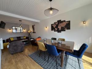 a living room with a table and chairs and a couch at Maison tranquille à Laprugne avec jardin et animaux admis - FR-1-489-448 in Laprugne