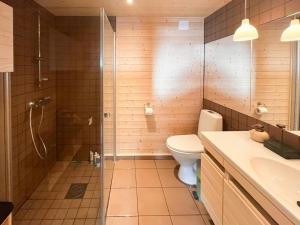 a bathroom with a shower and a toilet and a sink at Architectural Gem With Views Of Hallingskarvet in Ål