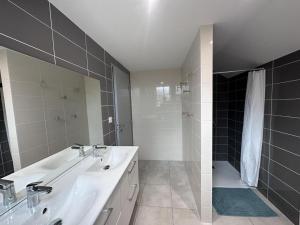 a bathroom with a white sink and a shower at Gîte historique rénové avec jardin et WiFi - FR-1-489-571 in Theneuille +14 photos