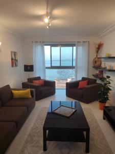 a living room with two couches and a coffee table at Seaview Tanger Apartment in Tangier