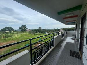 a balcony of a building with a view of a field at PK Residency in Yelagiri +4 photos