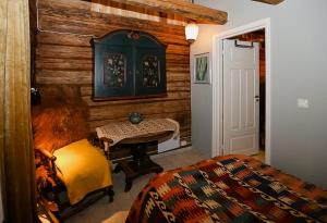 a bedroom with a bed and a table and a door at Historic Cabin By The Ski Trail In Østmarka in Omberg