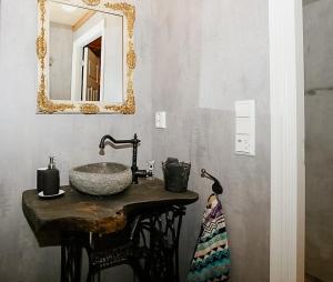 a bathroom with a sink and a mirror on the wall at Historic Cabin By The Ski Trail In Østmarka in Omberg