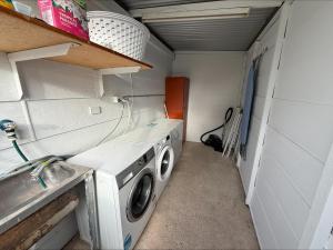 a washer and dryer in a small room at 3 by the Sea at Coobowie Unit 2 in Coobowie