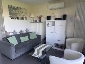 a living room with a couch and a coffee table at Maison de charme avec terrasse privée et activités familiales, proche de Souvigny et St Pourçain sur Sioule - FR-1-489-93 in Meillard