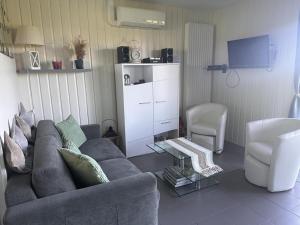 a living room with a couch and a tv at Maison de charme avec terrasse privée et activités familiales, proche de Souvigny et St Pourçain sur Sioule - FR-1-489-93 in Meillard +18 photos