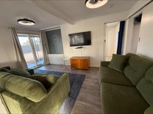 a living room with a couch and a tv at 3 by the Sea at Coobowie Unit 3 in Coobowie