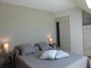 a bedroom with a bed with two pillows and two lamps at Gîte rénové à Chapeau avec wifi, terrasse et parking - FR-1-489-269 in Chapeau