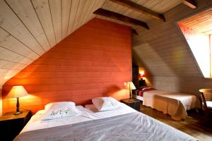 1 dormitorio con 2 camas en una pared de madera en Chambres de la Ville d'Ys, en Cléden-Cap-Sizun