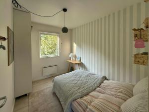 a bedroom with a bed and a window at Modern Holiday Home Close To Odden Beach in Tjørneholm