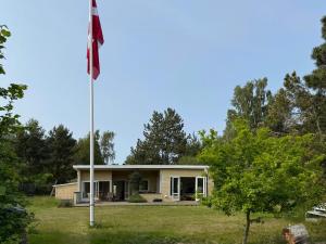 a flag pole in front of a house at Modern Holiday Home Close To Odden Beach in Tjørneholm