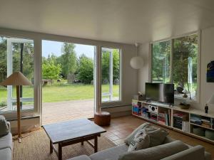 a living room with a couch and a tv at Modern Holiday Home Close To Odden Beach in Tjørneholm