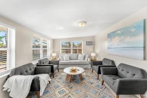 a living room with couches and a table at 721 Java Rd in Cocoa Beach