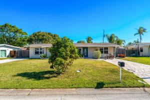 a house with a tree in the front yard at 721 Java Rd in Cocoa Beach