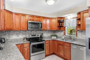 a kitchen with wooden cabinets and a stove top oven at 721 Java Rd in Cocoa Beach