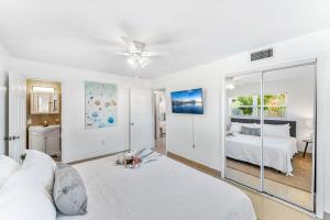 a white room with a bed and a window at 721 Java Rd in Cocoa Beach